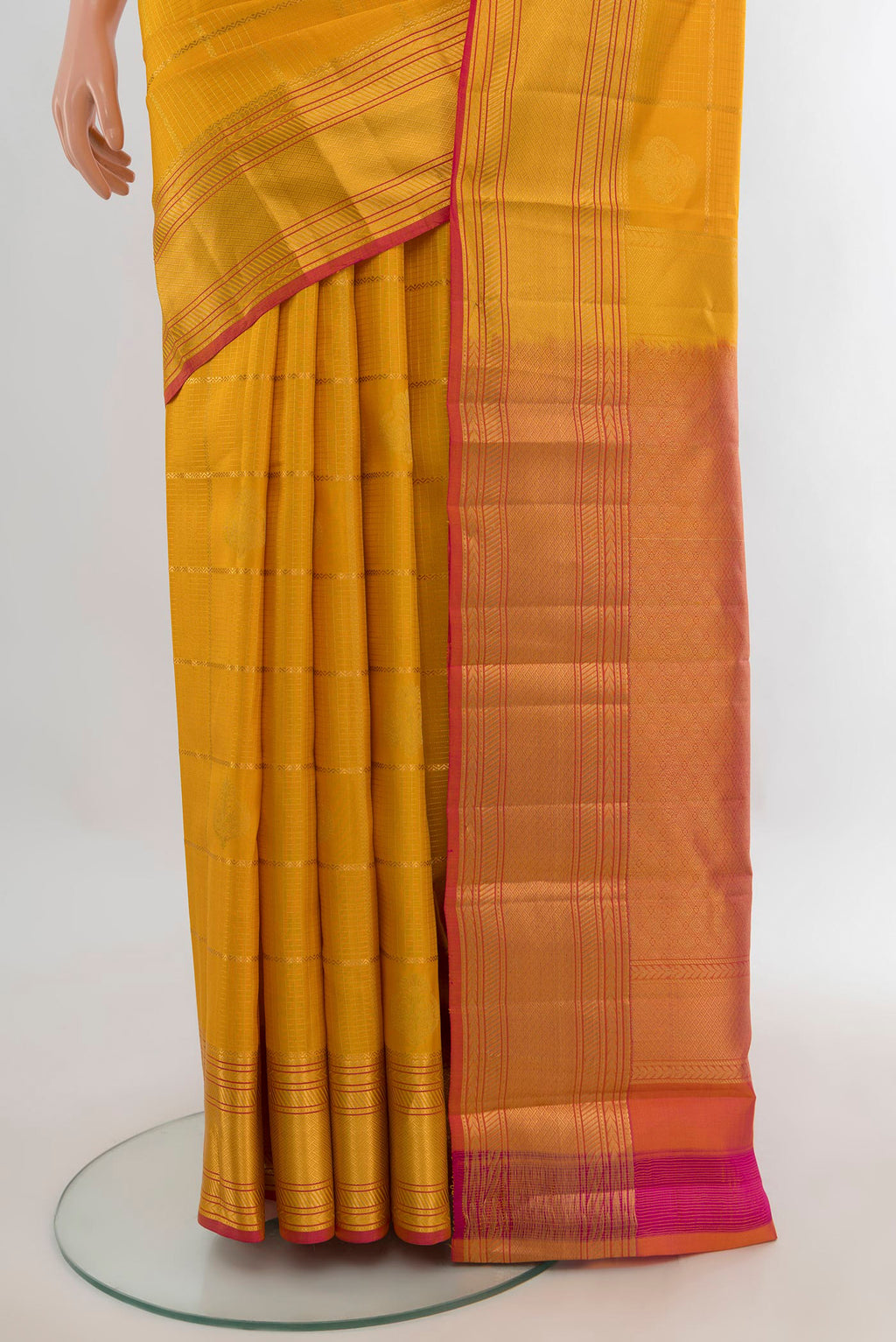 Pleats and pallu of Pure Silk Mustard Kanchipuram Saree with Checked design on the body and Zari Border. 