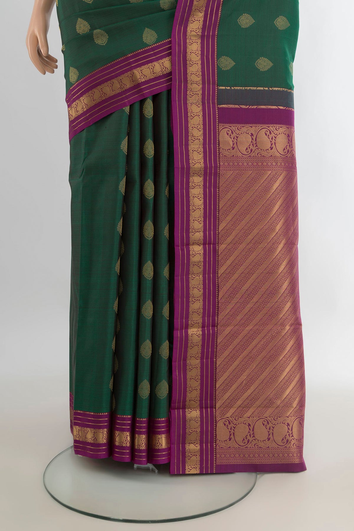 Pleats and pallu of Pure Silk Bottle Green Kanchipuram Saree with Zari Butta on the body and Zari Border. 