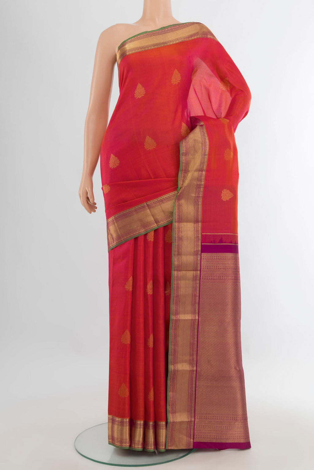 Pure Silk Orange Kanchipuram Saree with Zari Butta on the body and Zari Border.  displayed on a mannequin