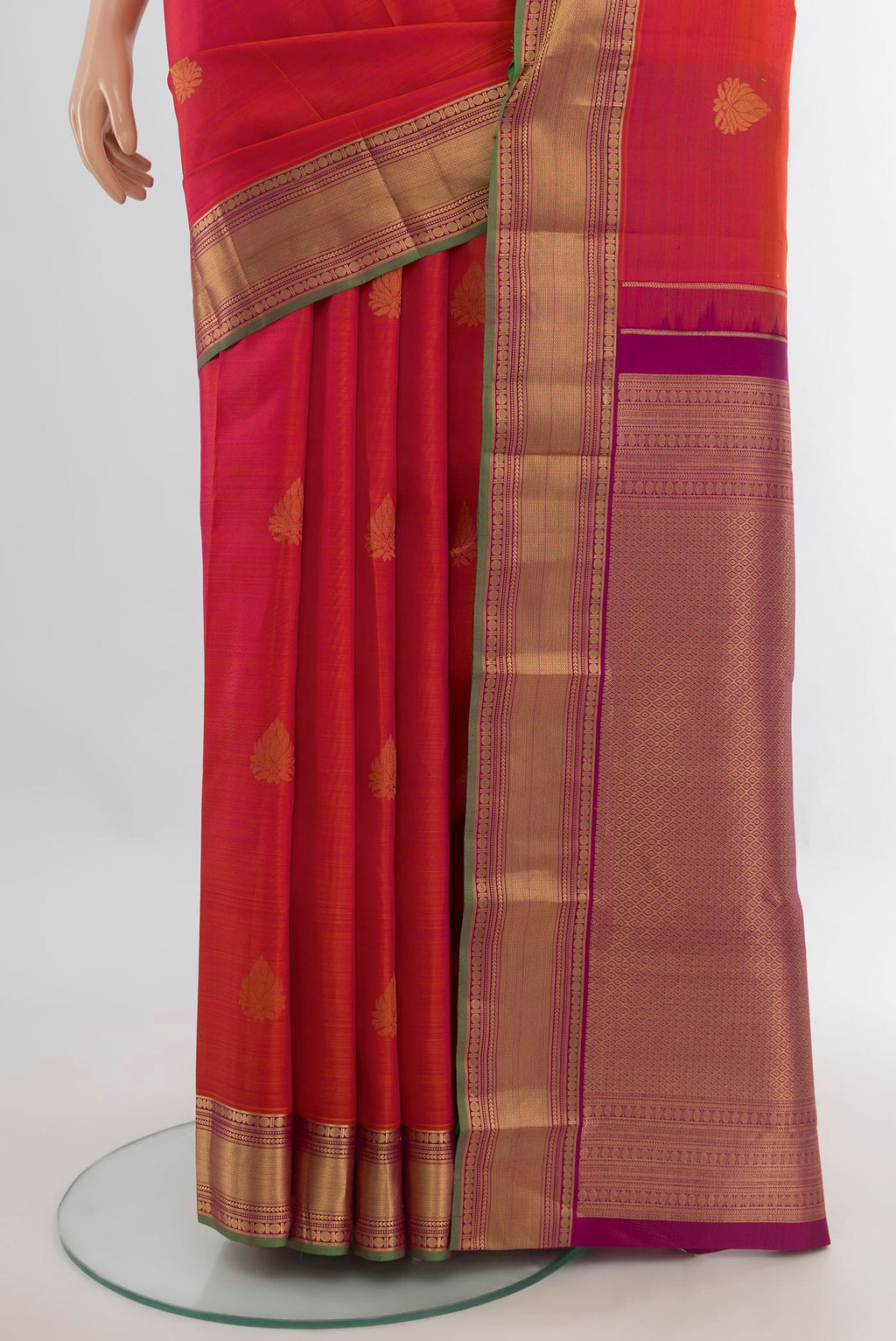 Pleats and pallu of Pure Silk Orange Kanchipuram Saree with Zari Butta on the body and Zari Border. 