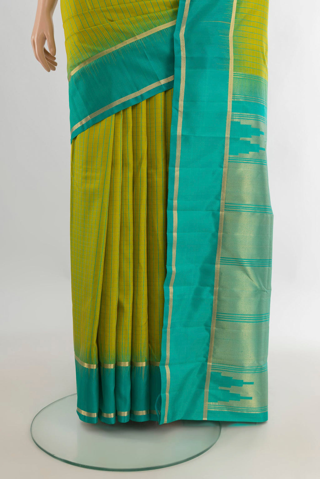 Pleats and pallu of Pure Silk Parrot Green Kanchipuram Saree with Checked design on the body and Plain Border. 