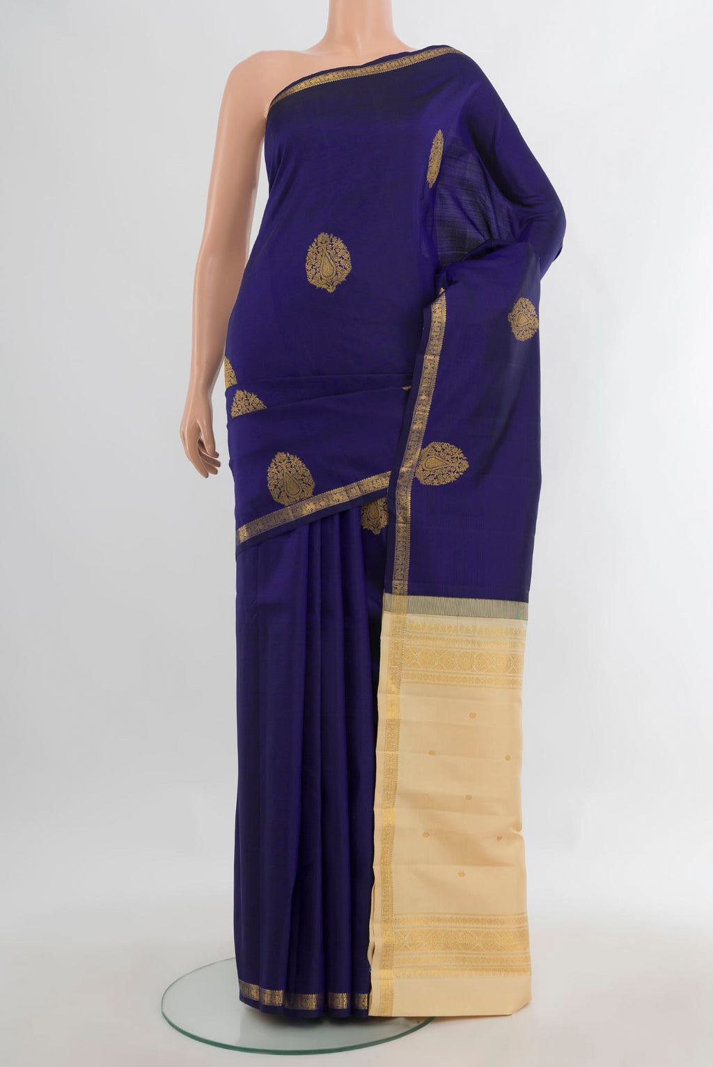 Pure Silk Navy Blue Kanchipuram Saree with Zari Butta on the body and Zari Border.  displayed on a mannequin