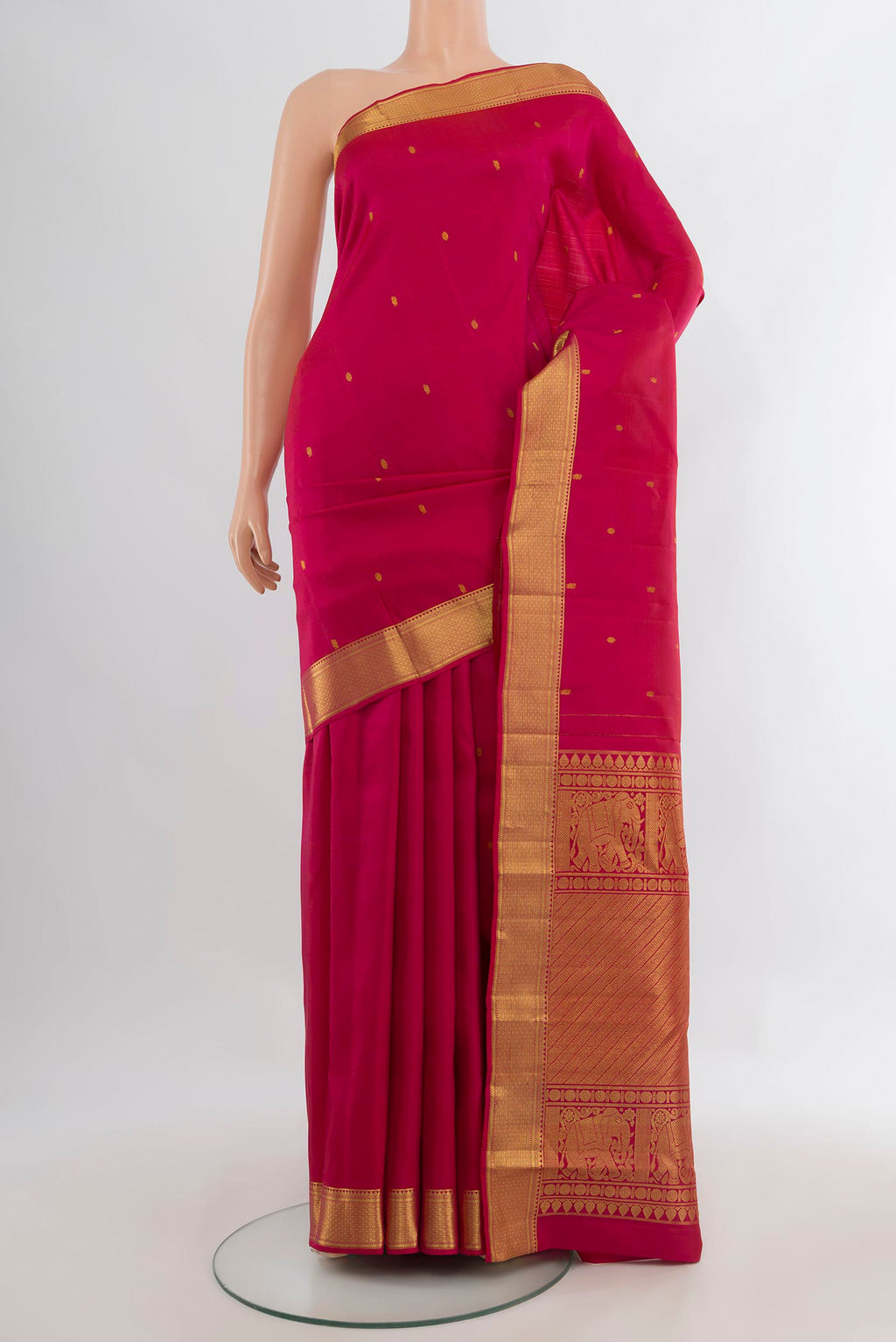 Pure Silk Dark Pink Kanjivaram Saree with Zari Butta on the body and Zari Border.  displayed on a mannequin