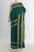 Pure Silk Bottle Green Kanjivaram Saree with Zari Butta on the body and Zari Border.  displayed on a mannequin