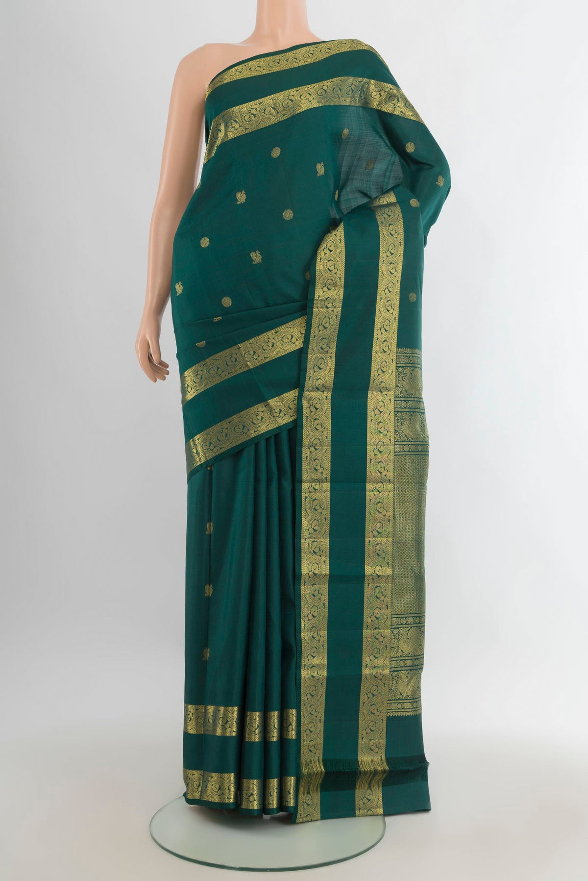 Pure Silk Bottle Green Kanjivaram Saree with Zari Butta on the body and Zari Border.  displayed on a mannequin