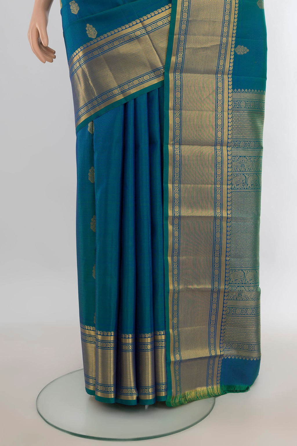 Pleats and pallu of Pure Silk Peacock Blue Kanjivaram Saree with Zari Butta on the body and Silk Border. 