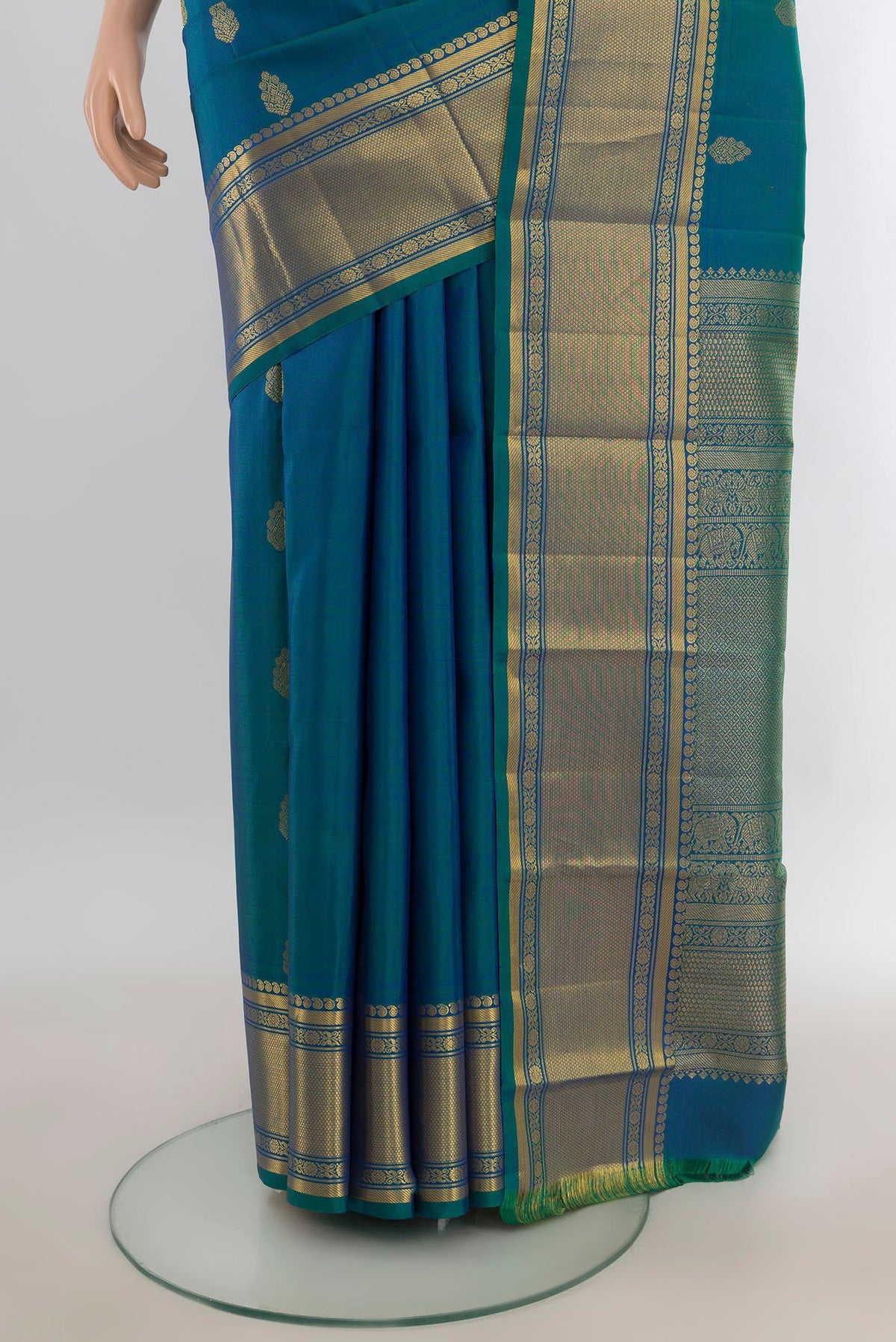 Pleats and pallu of Pure Silk Peacock Blue Kanjivaram Saree with Zari Butta on the body and Silk Border. 