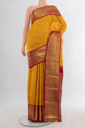 Pure Silk Mustard Kanjivaram Saree with Zari Butta on the body and Zari Border.  displayed on a mannequin