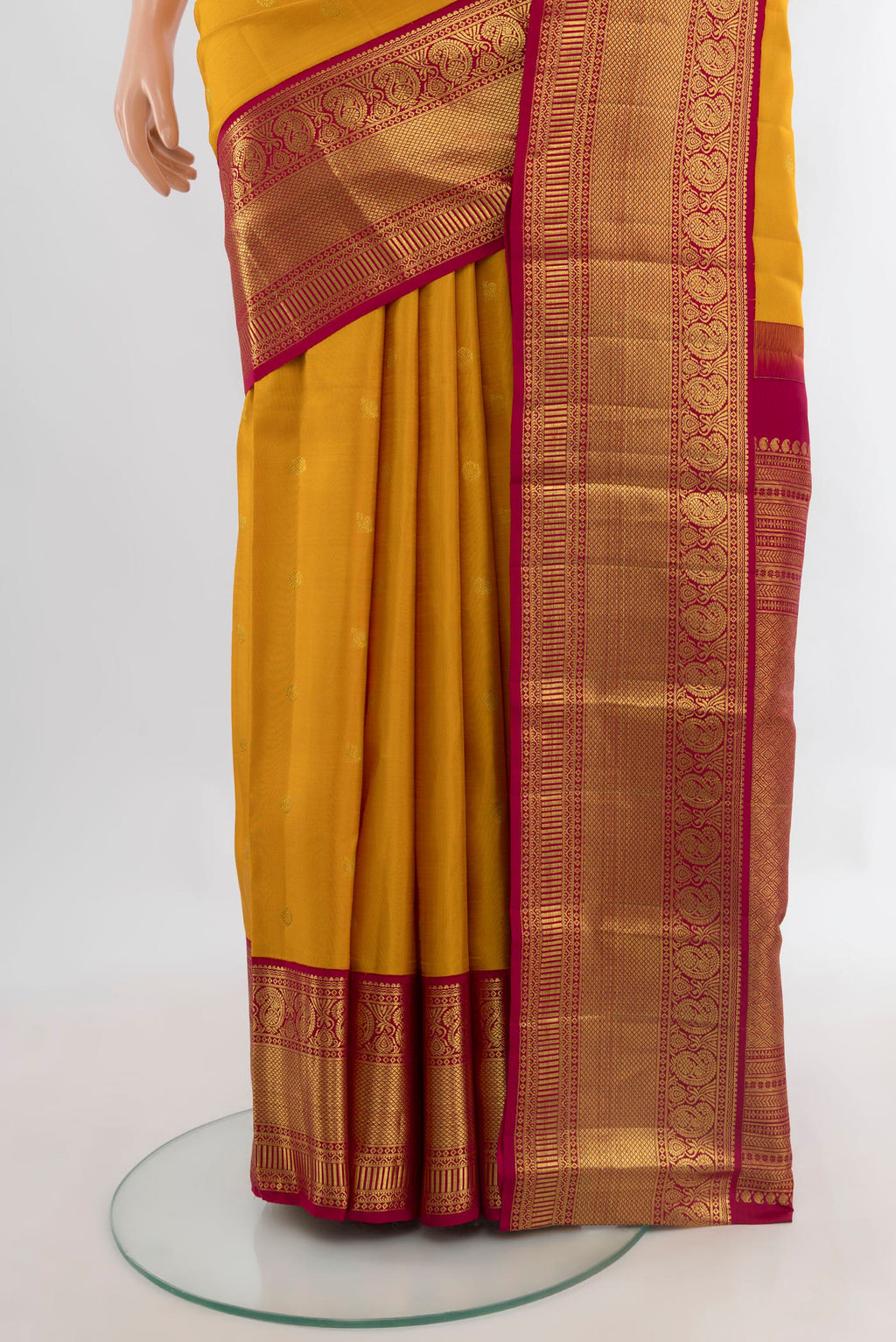 Pleats and pallu of Pure Silk Mustard Kanjivaram Saree with Zari Butta on the body and Zari Border. 
