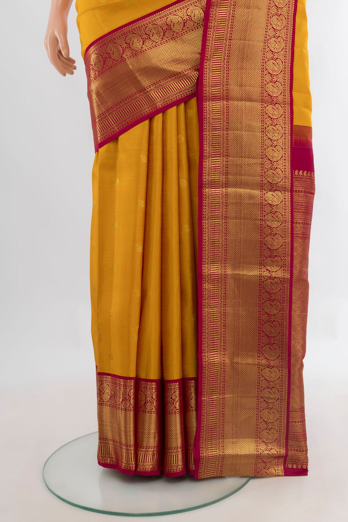 Pleats and pallu of Pure Silk Mustard Kanjivaram Saree with Zari Butta on the body and Zari Border. 