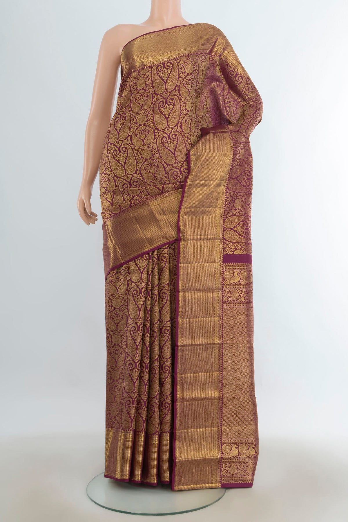 Pure Silk Maroon Kanchipuram Saree with Zari Butta on the body and Silk Border.  displayed on a mannequin
