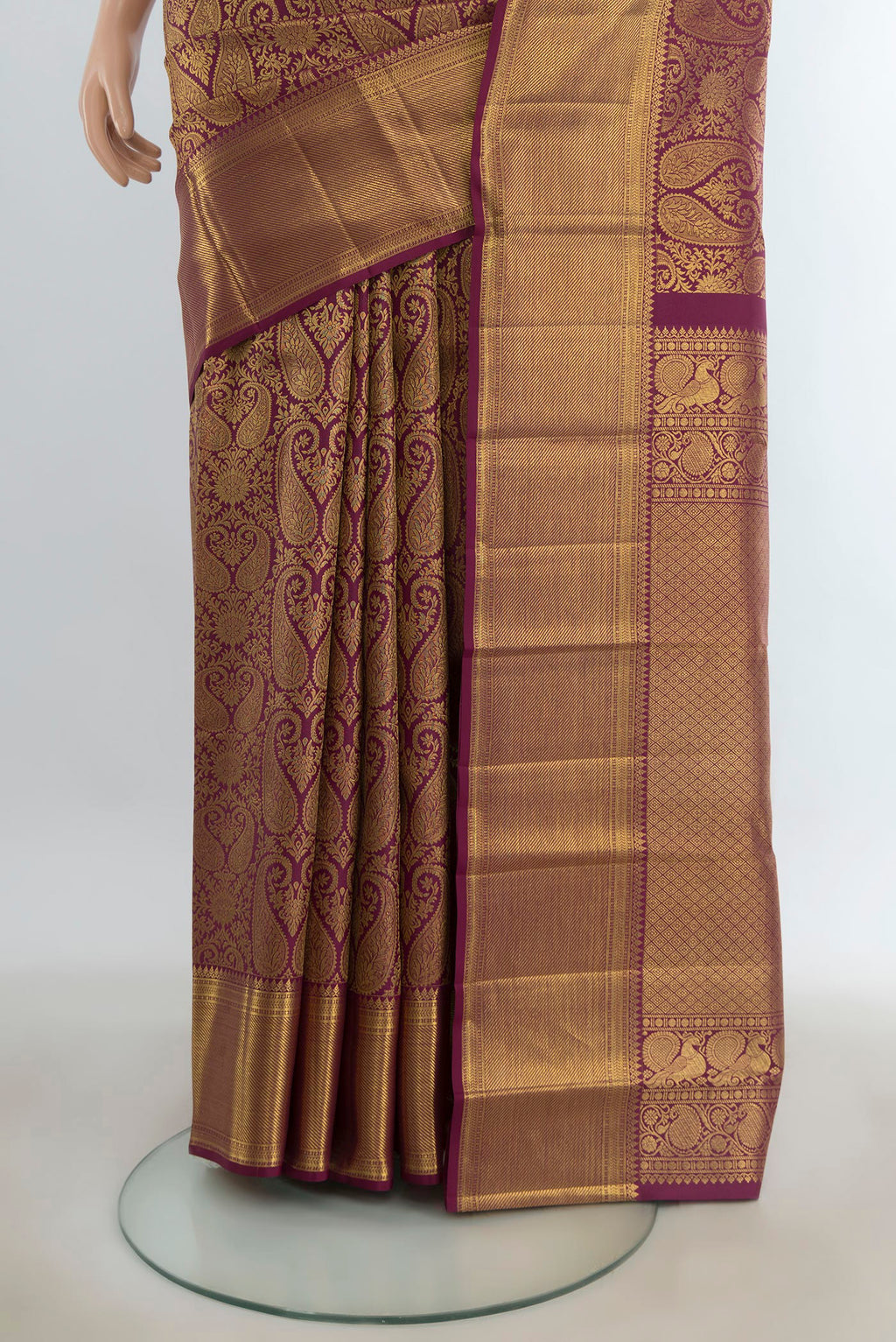 Pleats and pallu of Pure Silk Maroon Kanchipuram Saree with Zari Butta on the body and Silk Border. 