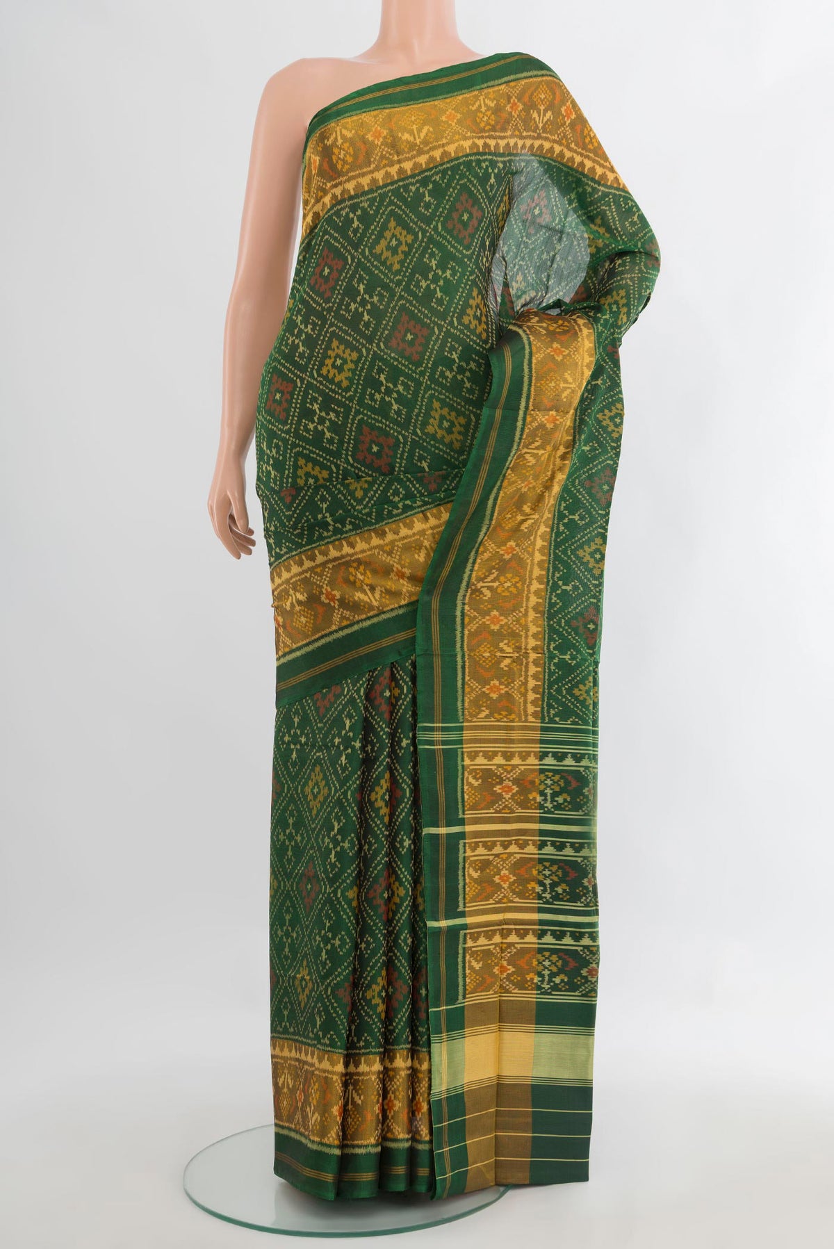Pure Silk Green Rajkot Patola Saree with Pure Ikat on the body and Ikat Border.  displayed on a mannequin