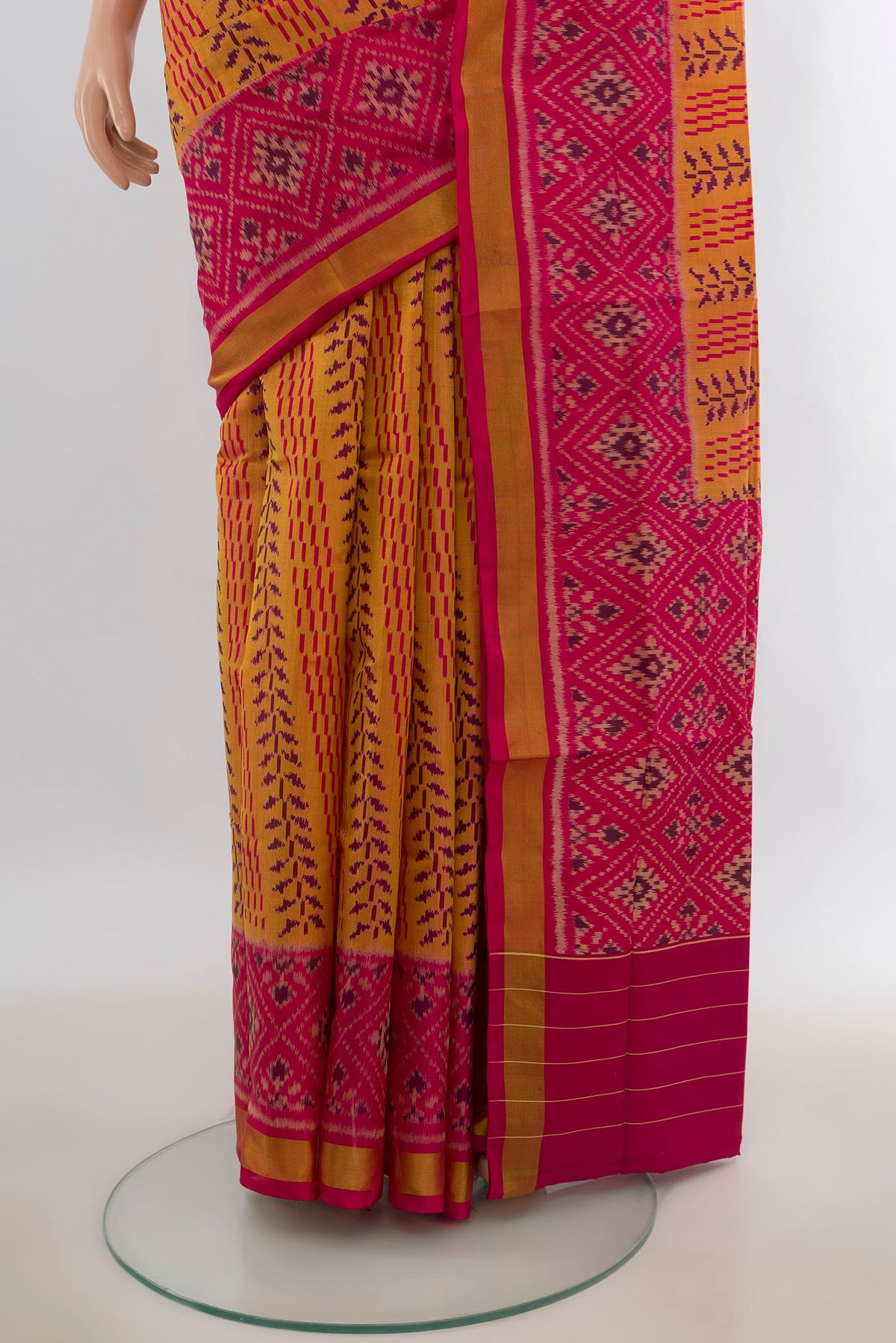 Pleats and pallu of Pure Silk Mustard Rajkot Patola Saree with Pure Ikat on the body and Ikat Border. 