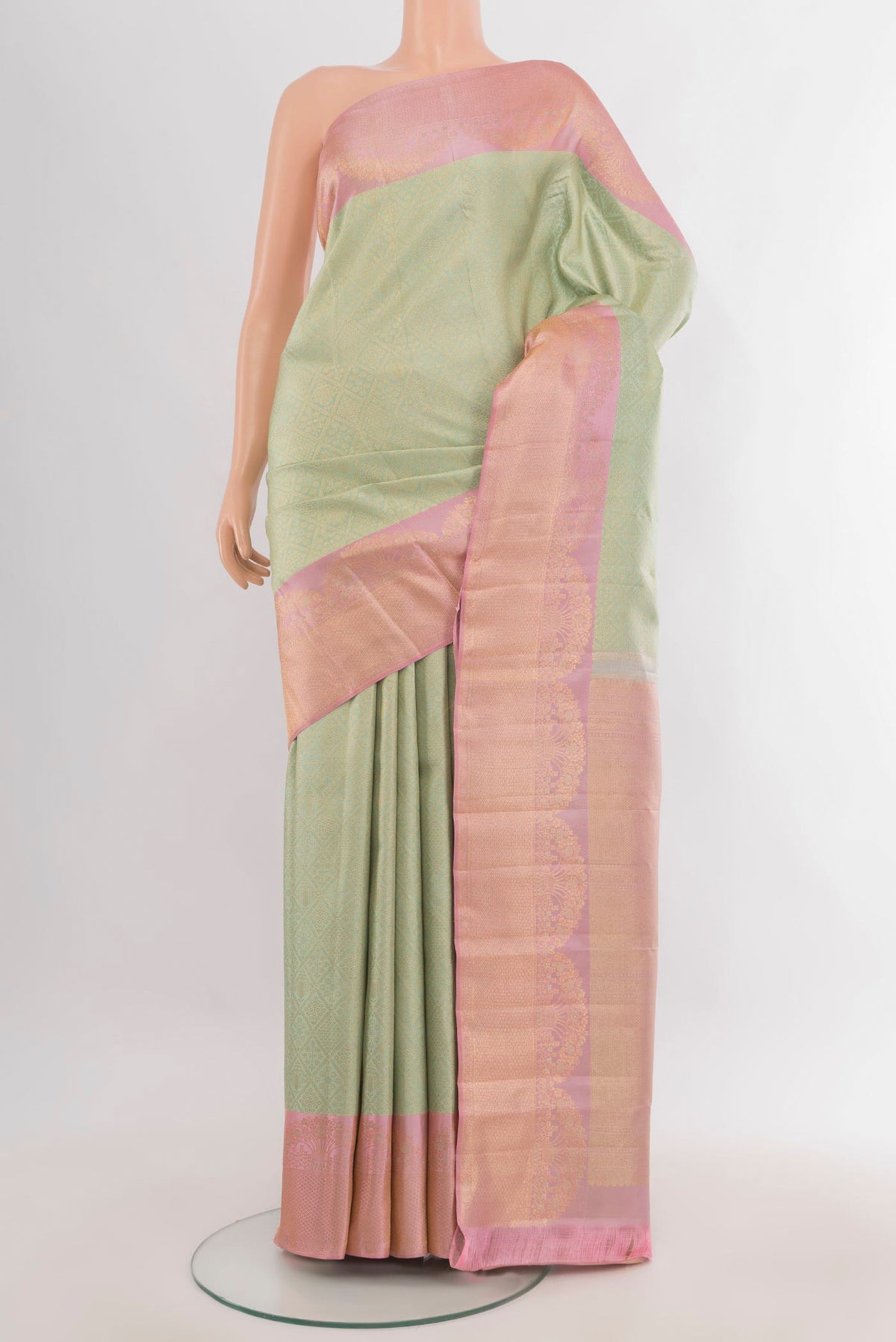 Pure Silk Light Green Kanchipuram Saree with Zari Butta on the body and Fancy Border.  displayed on a mannequin