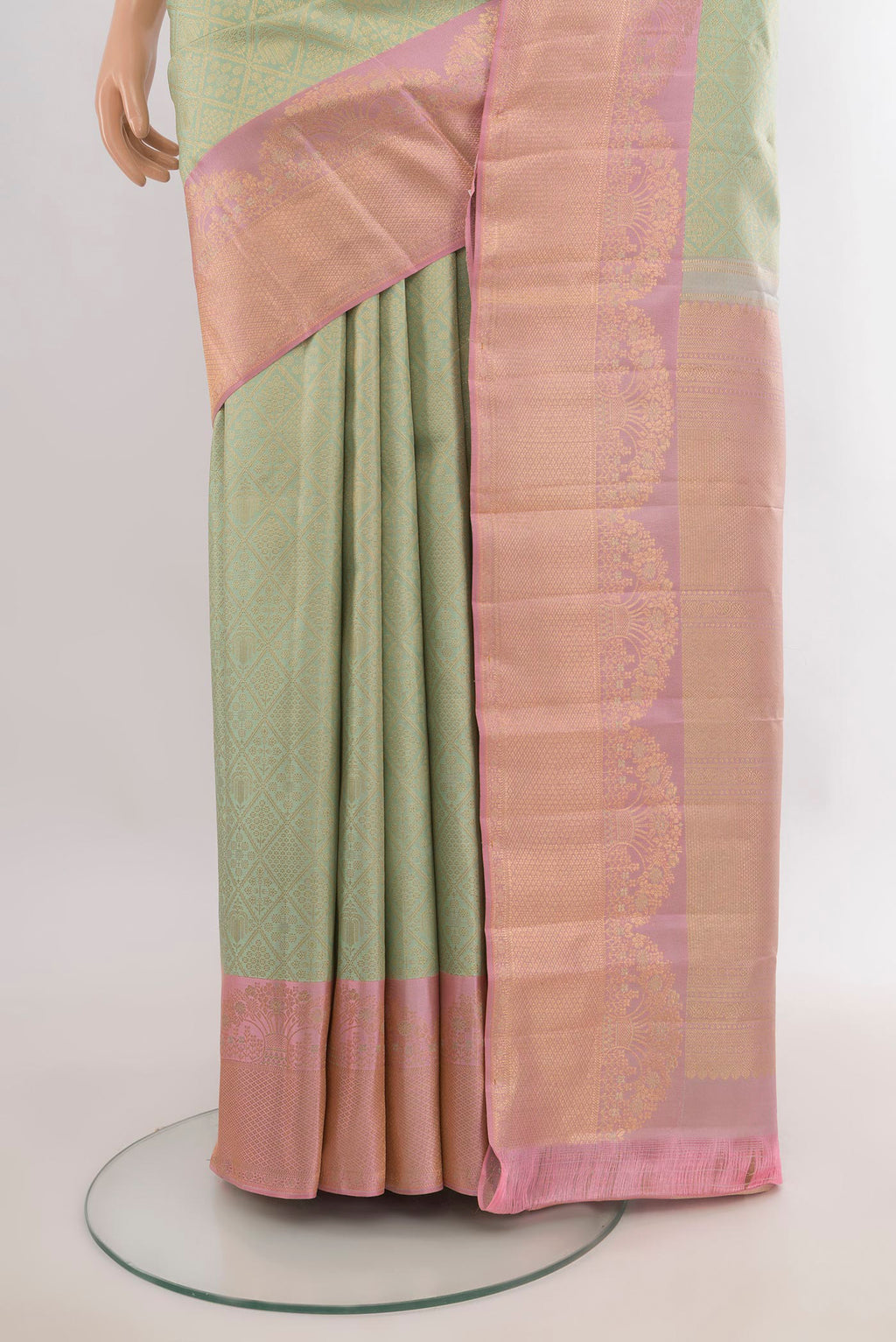 Pleats and pallu of Pure Silk Light Green Kanchipuram Saree with Zari Butta on the body and Fancy Border. 