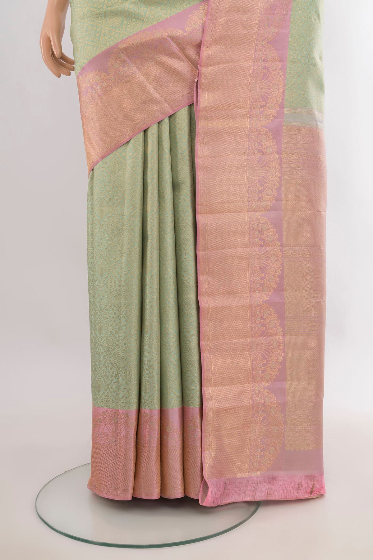 Pleats and pallu of Pure Silk Light Green Kanchipuram Saree with Zari Butta on the body and Fancy Border. 
