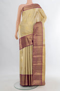 Golden Kanchipuram Tissue Saree with Zari Butta on the body and Zari Border.  displayed on a mannequin