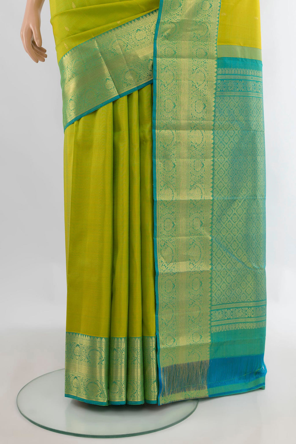 Pleats and pallu of Pure Silk Parrot Green Kanchipuram Saree with Zari Butta on the body and Zari Border. 