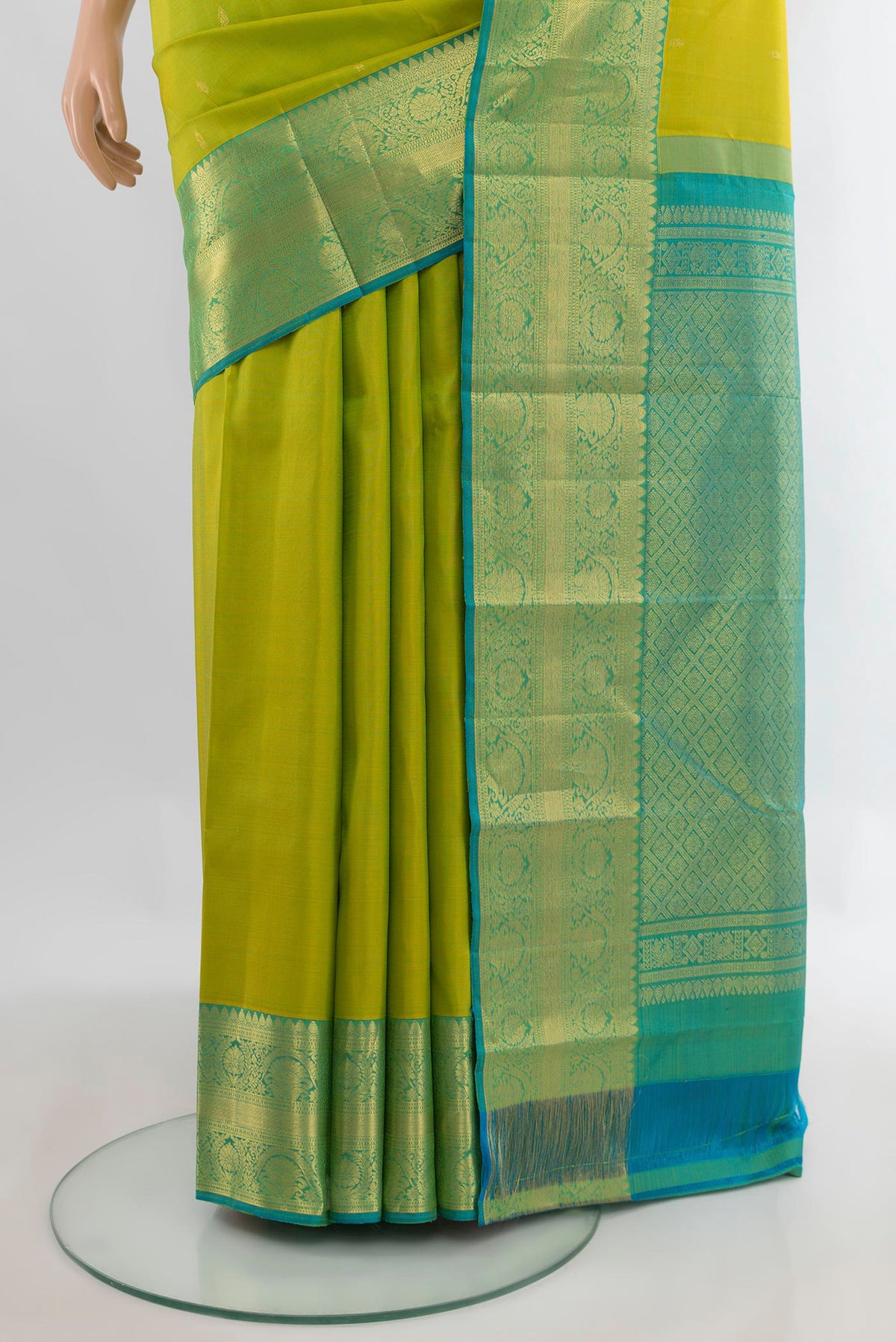 Pleats and pallu of Pure Silk Parrot Green Kanchipuram Saree with Zari Butta on the body and Zari Border. 