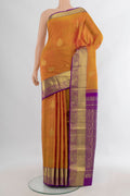 Pure Silk Mustard Kanchipuram Saree with Zari Butta on the body and Zari Border.  displayed on a mannequin