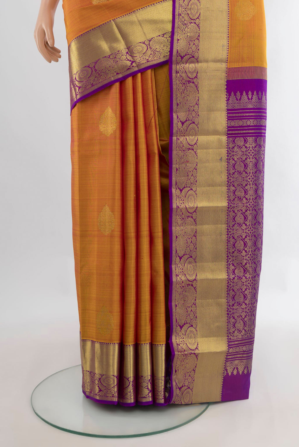 Pleats and pallu of Pure Silk Mustard Kanchipuram Saree with Zari Butta on the body and Zari Border. 
