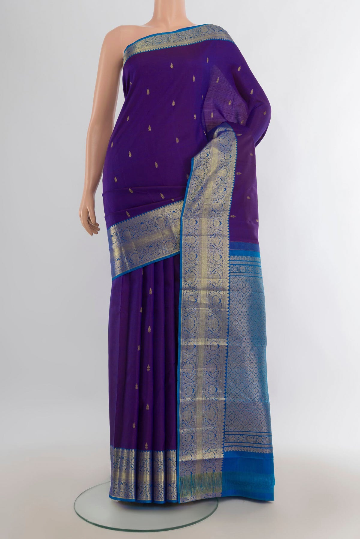 Pure Silk Violet Kanchipuram Saree with Zari Butta on the body and Silk Border.  displayed on a mannequin
