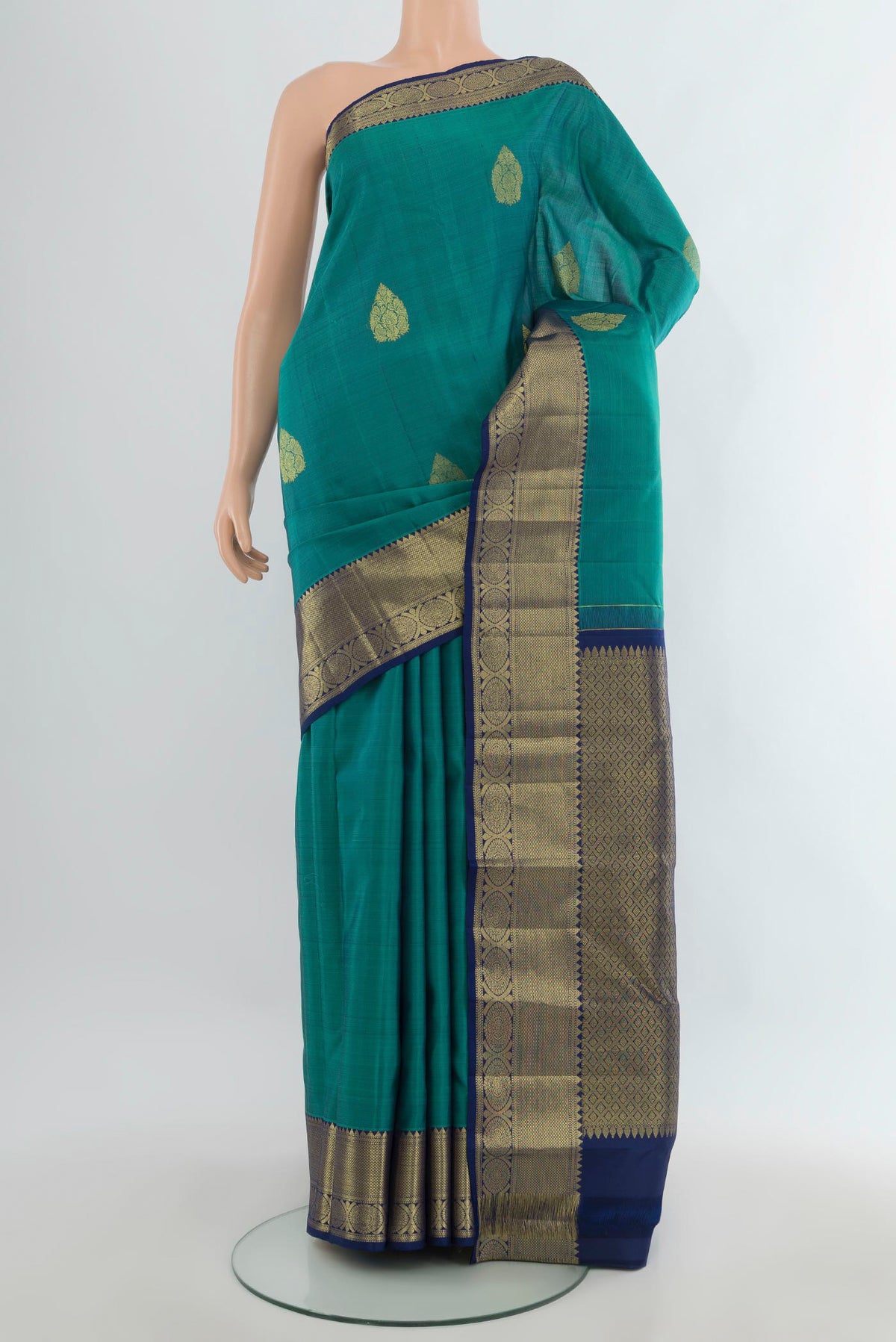 Pure Silk Sea Green Kanchipuram Saree with Zari Butta on the body and Zari Border.  displayed on a mannequin