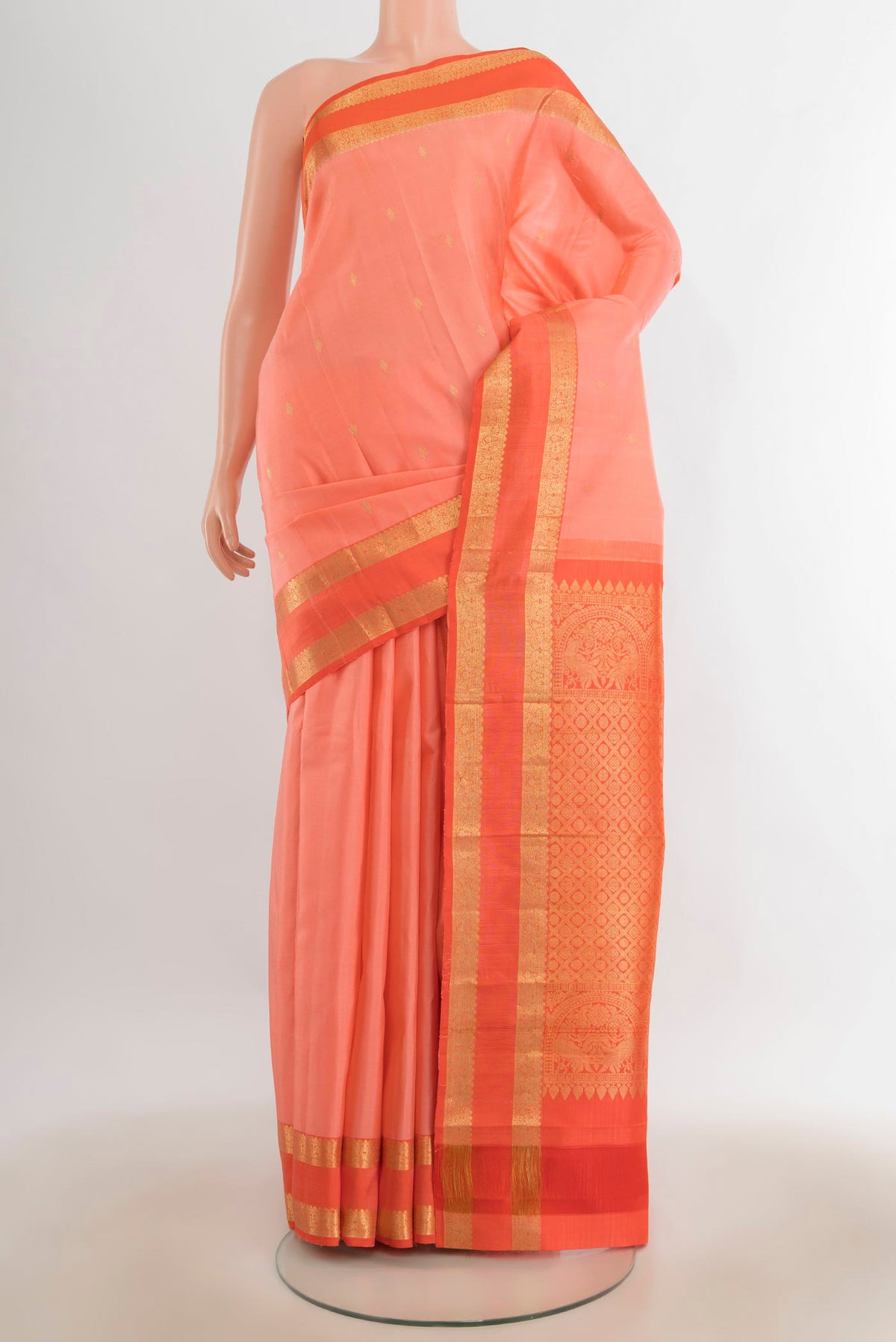 Pure Silk Rose Gold Kanchipuram Saree with Zari Butta on the body and Silk Border.  displayed on a mannequin