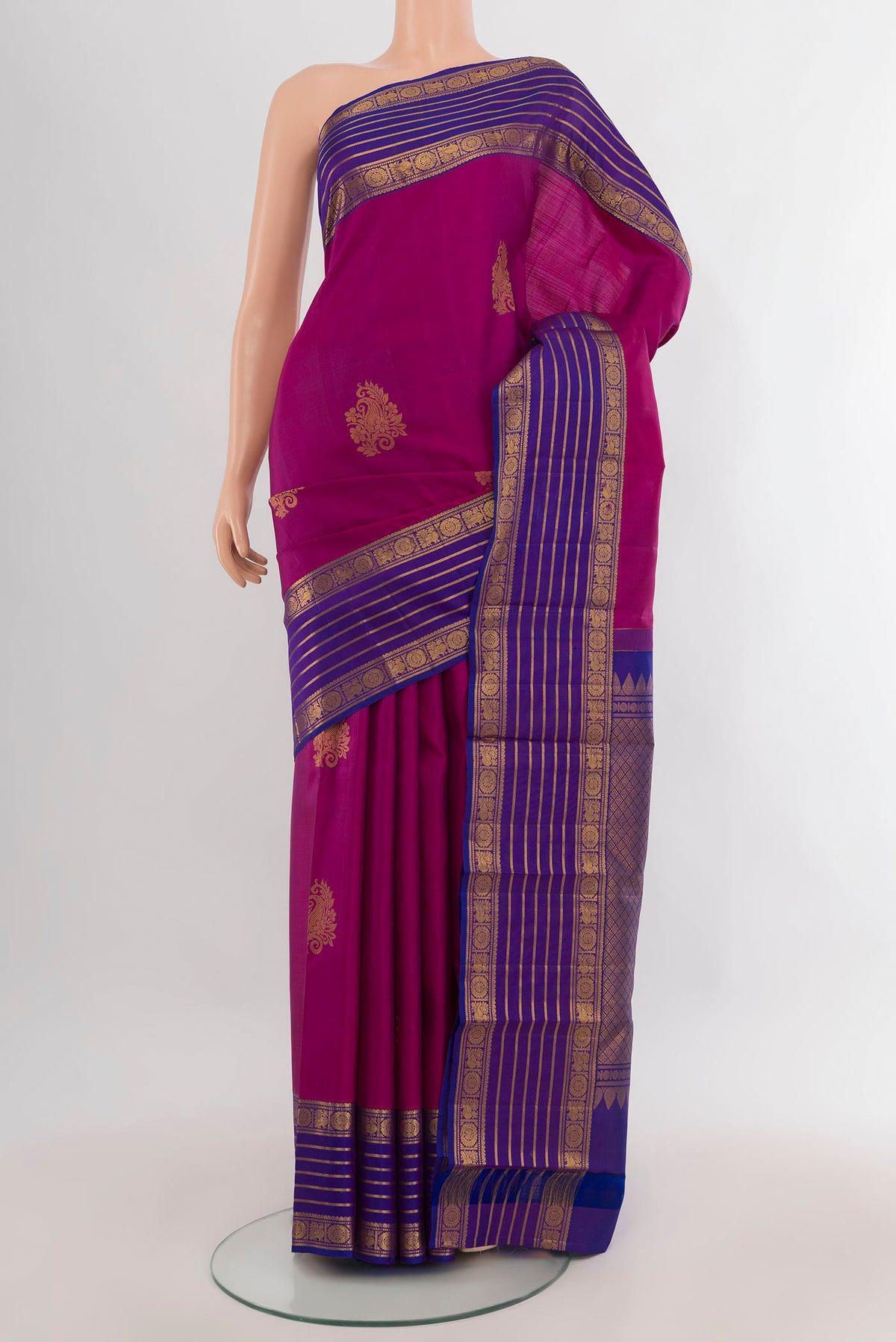 Pure Silk Magenta Kanchipuram Saree with Zari Butta on the body and Zari Border.  displayed on a mannequin