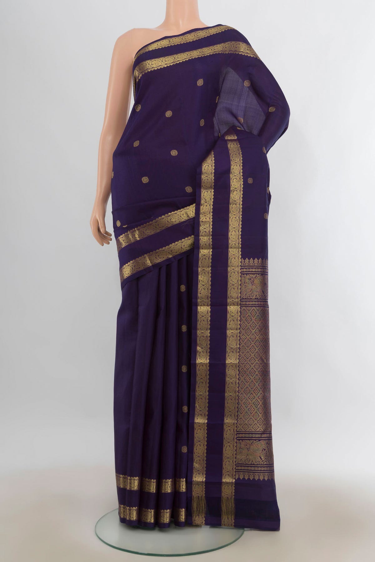 Pure Silk Navy Blue Kanchipuram Saree with Zari Butta on the body and Zari Border.  displayed on a mannequin