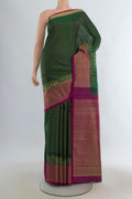 Pure Silk Green Kanjivaram Saree with Checked design on the body and Fancy Border.  displayed on a mannequin