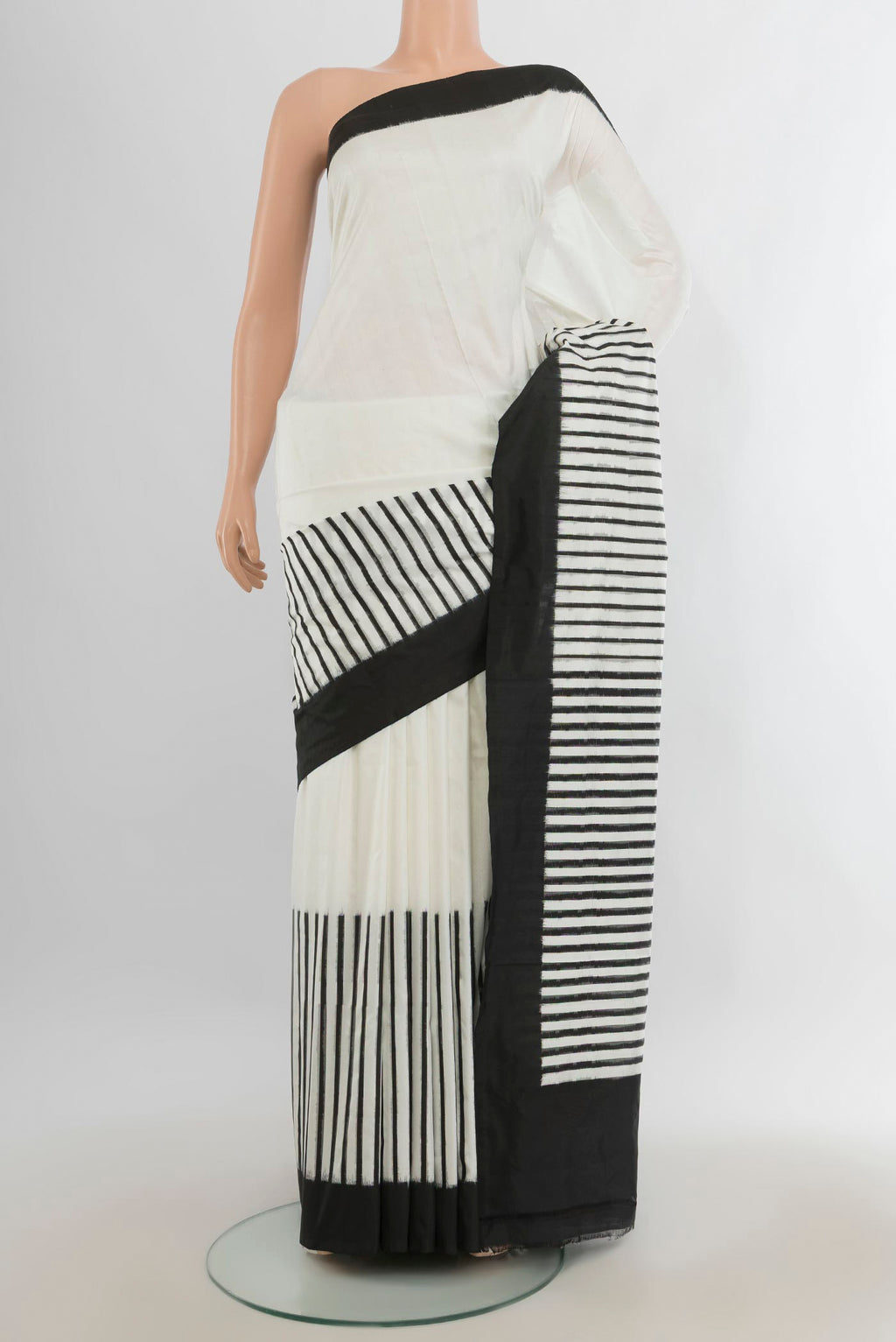 Pure Silk Off White Rajkot Patola Saree with Ikat Print on the body and Silk Border.  displayed on a mannequin