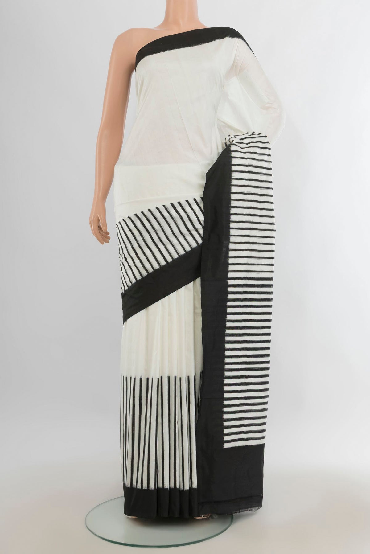 Pure Silk Off White Rajkot Patola Saree with Ikat Print on the body and Silk Border.  displayed on a mannequin