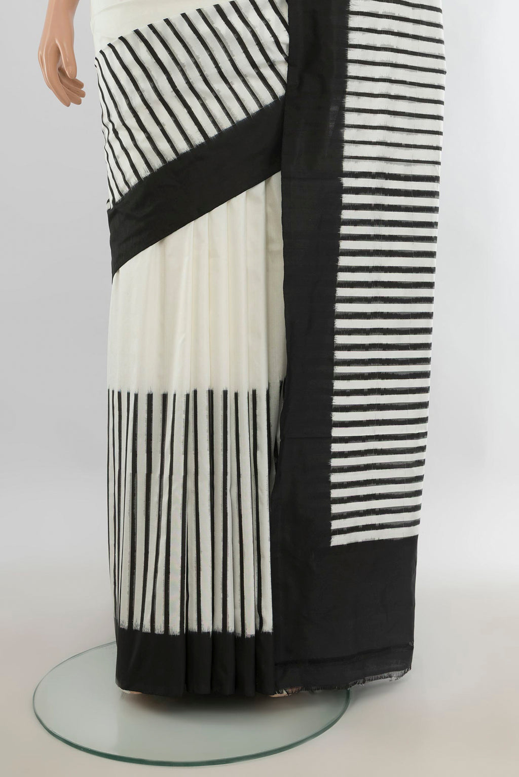 Pleats and pallu of Pure Silk Off White Rajkot Patola Saree with Ikat Print on the body and Silk Border. 