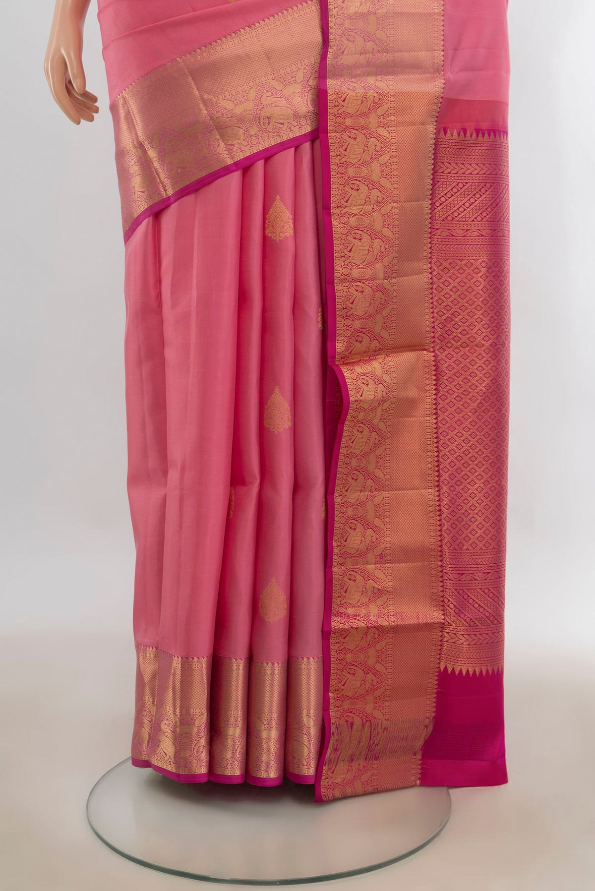 Pleats and pallu of Pure Silk Rose pink Soft Saree with Zari Butta on the body and Zari Border. 