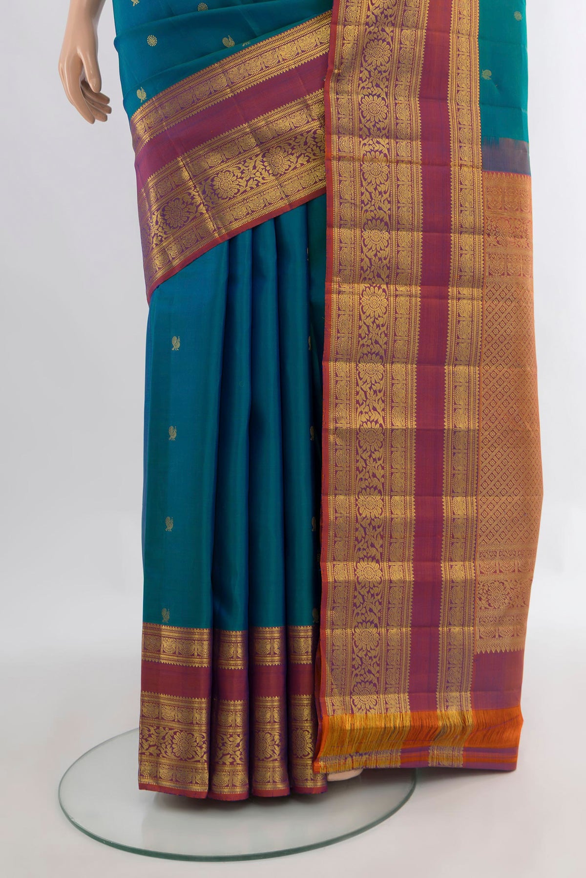Pleats and pallu of Pure Silk Peacock Blue Kanchipuram Saree with Zari Butta on the body and Zari Border. 
