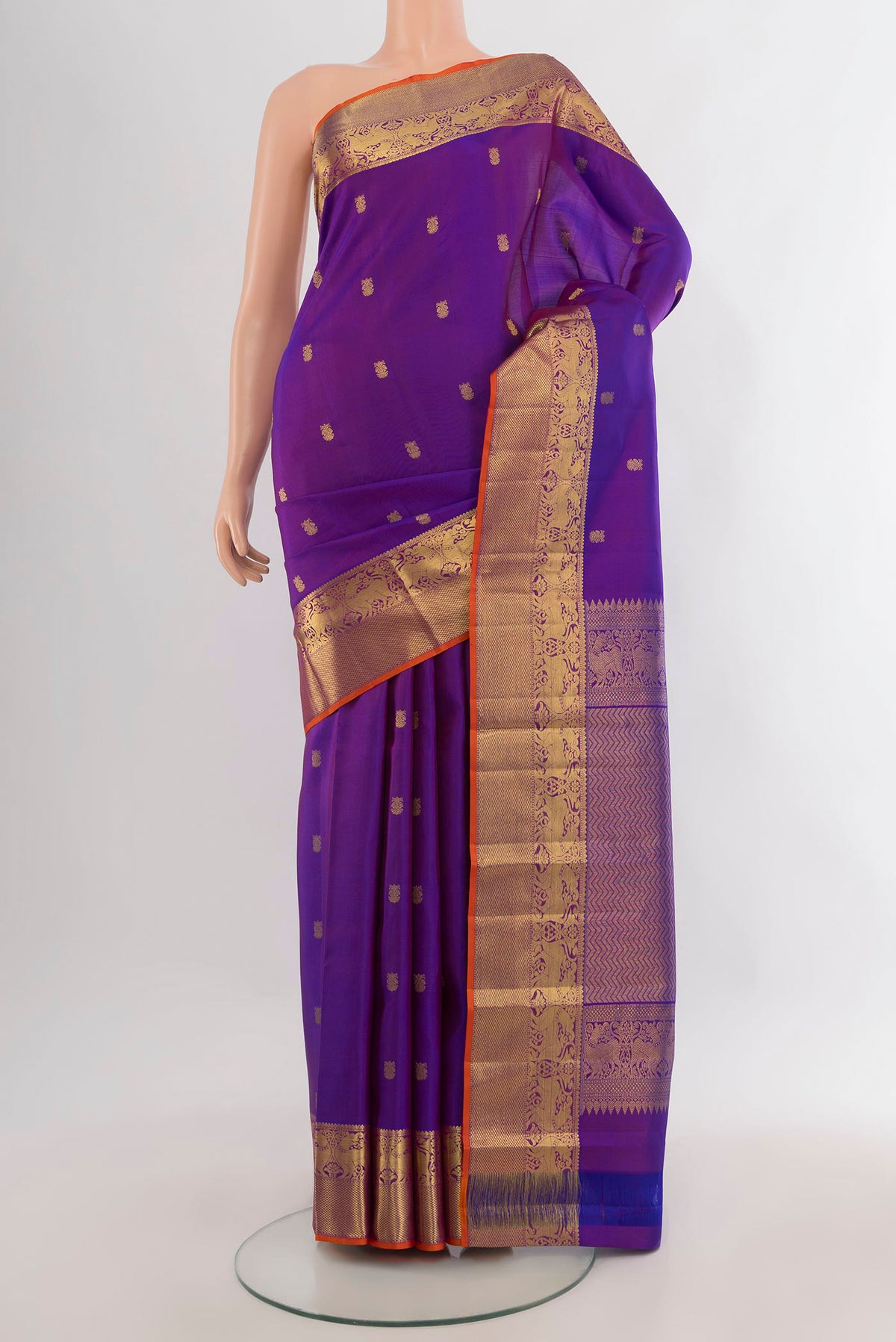 Pure Silk Purple Kanchipuram Saree with Zari Butta on the body and Zari Border.  displayed on a mannequin