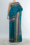 Pure Silk Pure Zari Peacock Blue Kanjivaram Saree with Zari Butta on the body and Silk Border.  displayed on a mannequin