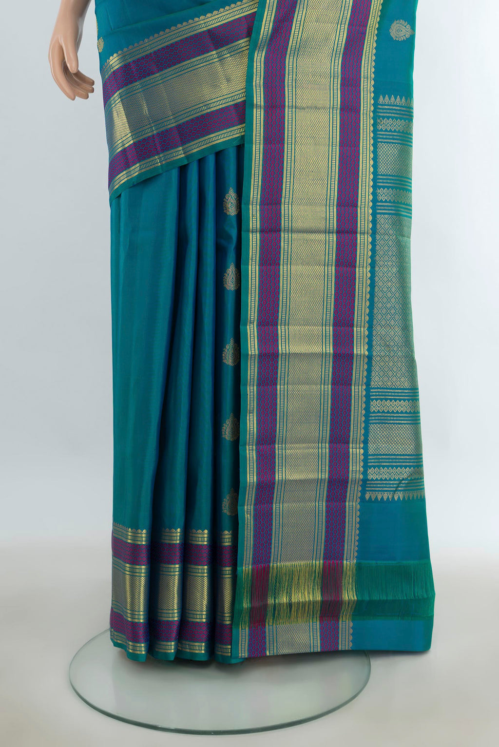 Pleats and pallu of Pure Silk Pure Zari Peacock Blue Kanjivaram Saree with Zari Butta on the body and Silk Border. 
