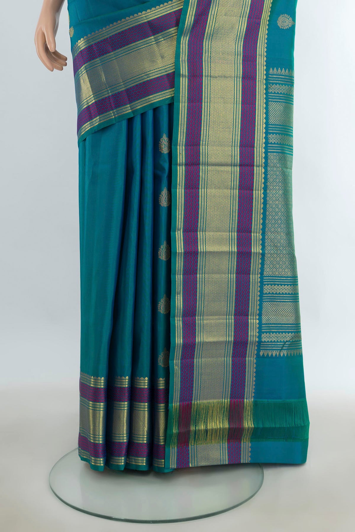 Pleats and pallu of Pure Silk Pure Zari Peacock Blue Kanjivaram Saree with Zari Butta on the body and Silk Border. 