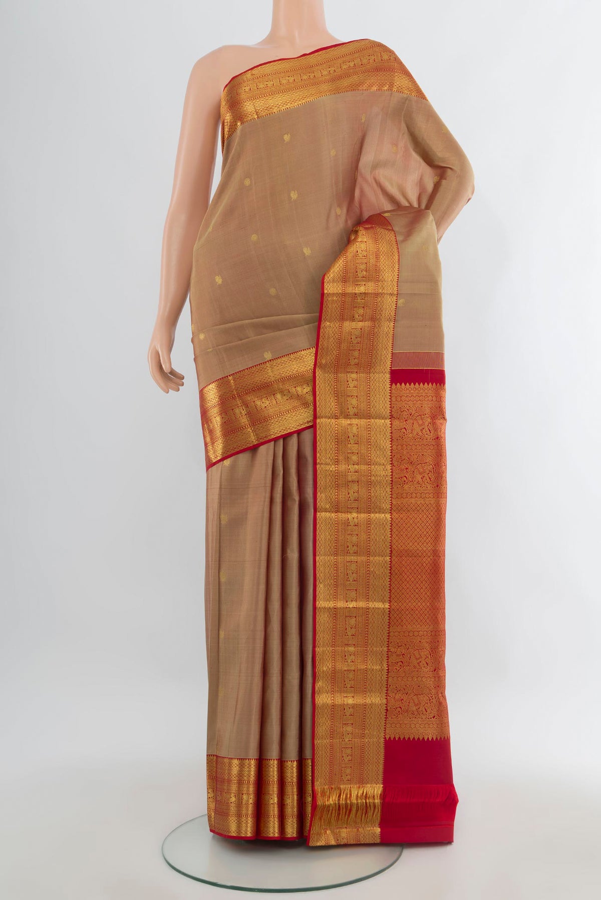 Pure Silk Sandal Kanchipuram Saree with Zari Butta on the body and Zari Border.  displayed on a mannequin
