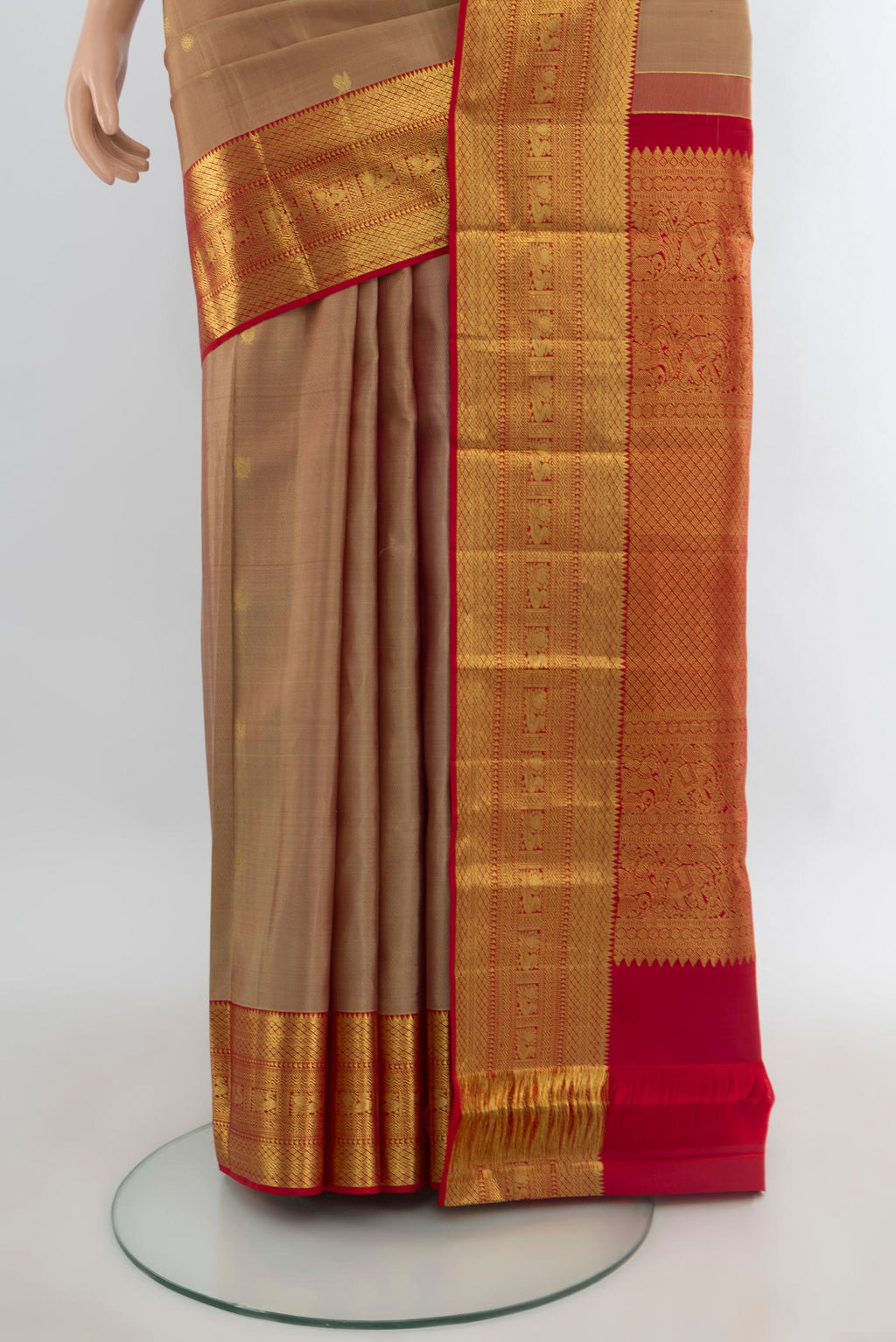 Pleats and pallu of Pure Silk Sandal Kanchipuram Saree with Zari Butta on the body and Zari Border. 