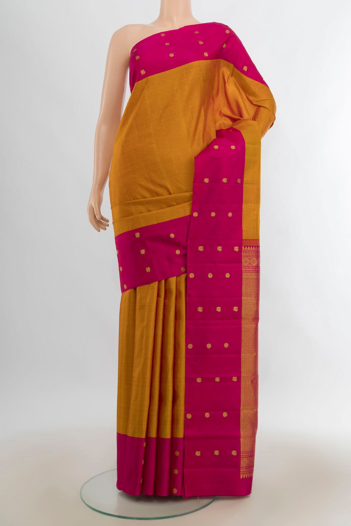 Pure Silk Rust Kanjivaram Saree with Zari Butta on the body and Silk Border.  displayed on a mannequin