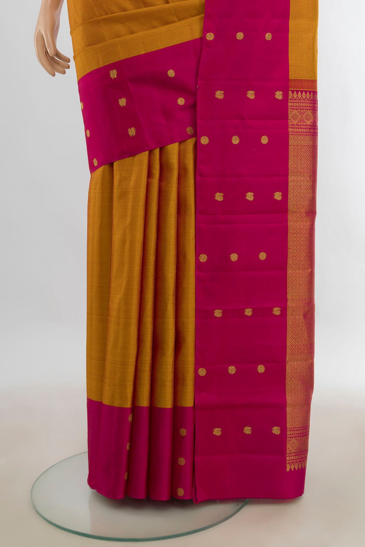 Pleats and pallu of Pure Silk Rust Kanjivaram Saree with Zari Butta on the body and Silk Border. 
