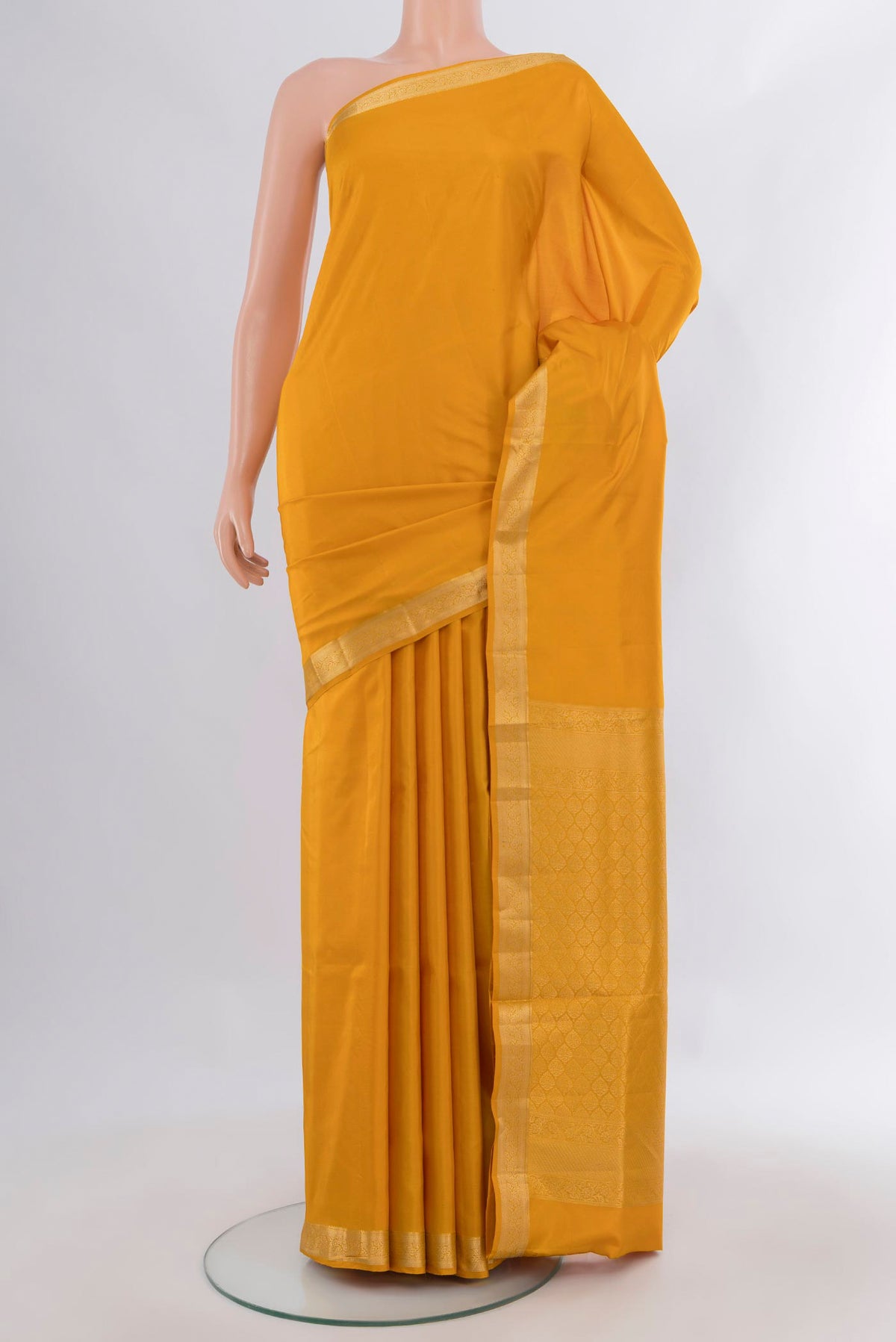 Pure Silk Yellow Soft Saree with Plain Body and Zari Border.  displayed on a mannequin