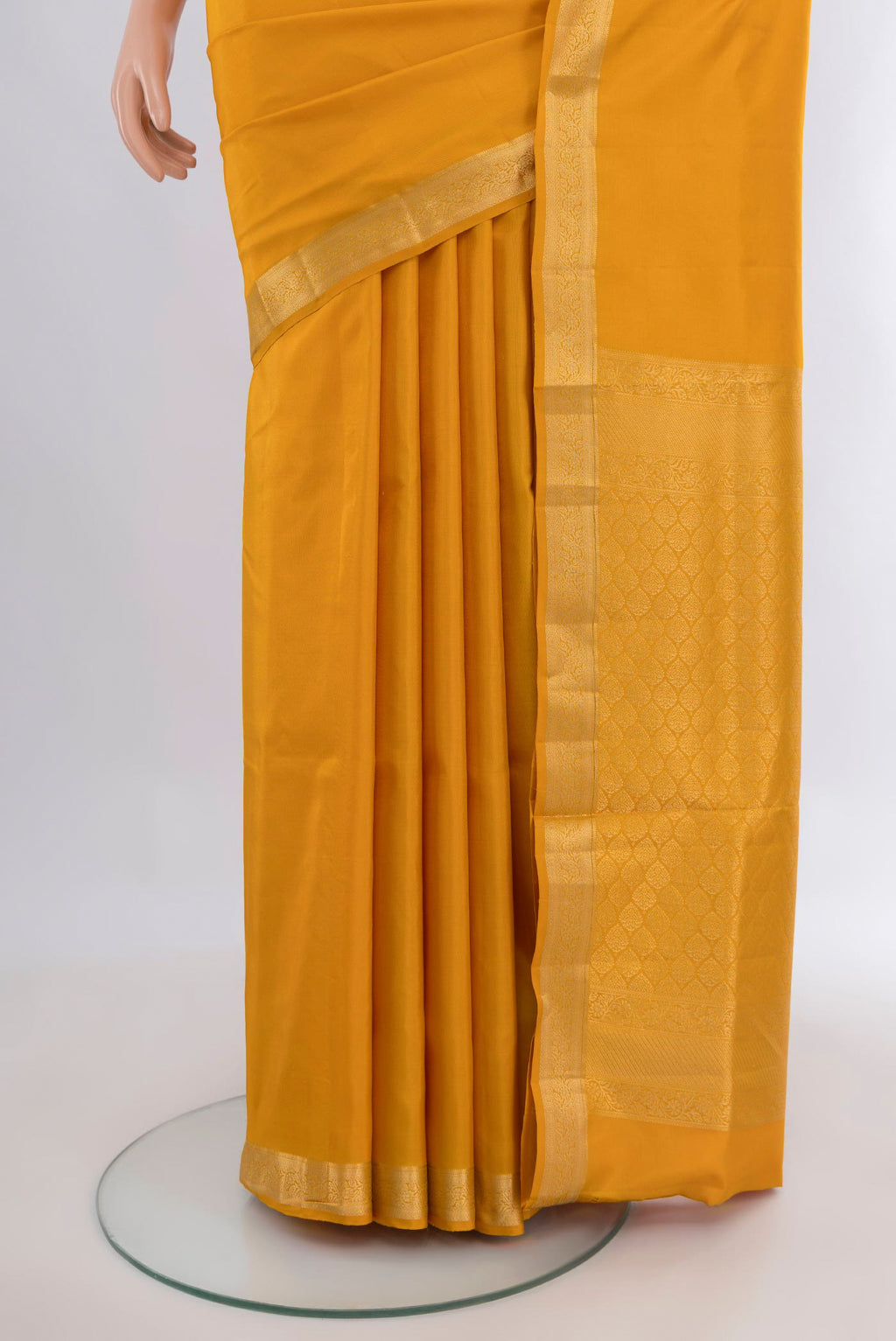 Pleats and pallu of Pure Silk Yellow Soft Saree with Plain Body and Zari Border. 