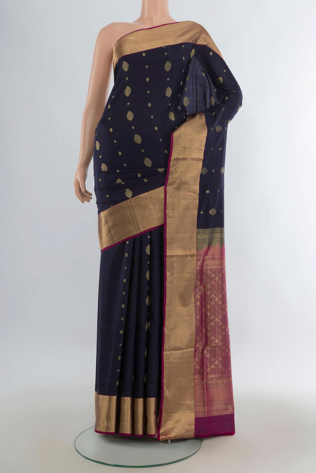 Pure Silk Navy Blue Soft Saree with Zari Butta on the body and Zari Border.  displayed on a mannequin