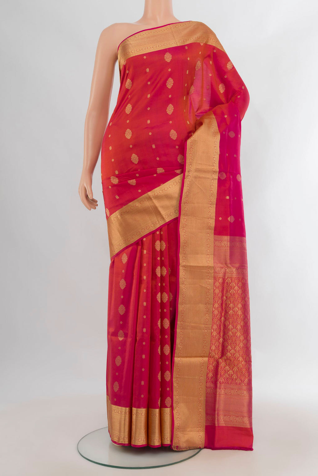 Pure Silk Orange Soft Saree with Zari Butta on the body and Zari Border.  displayed on a mannequin