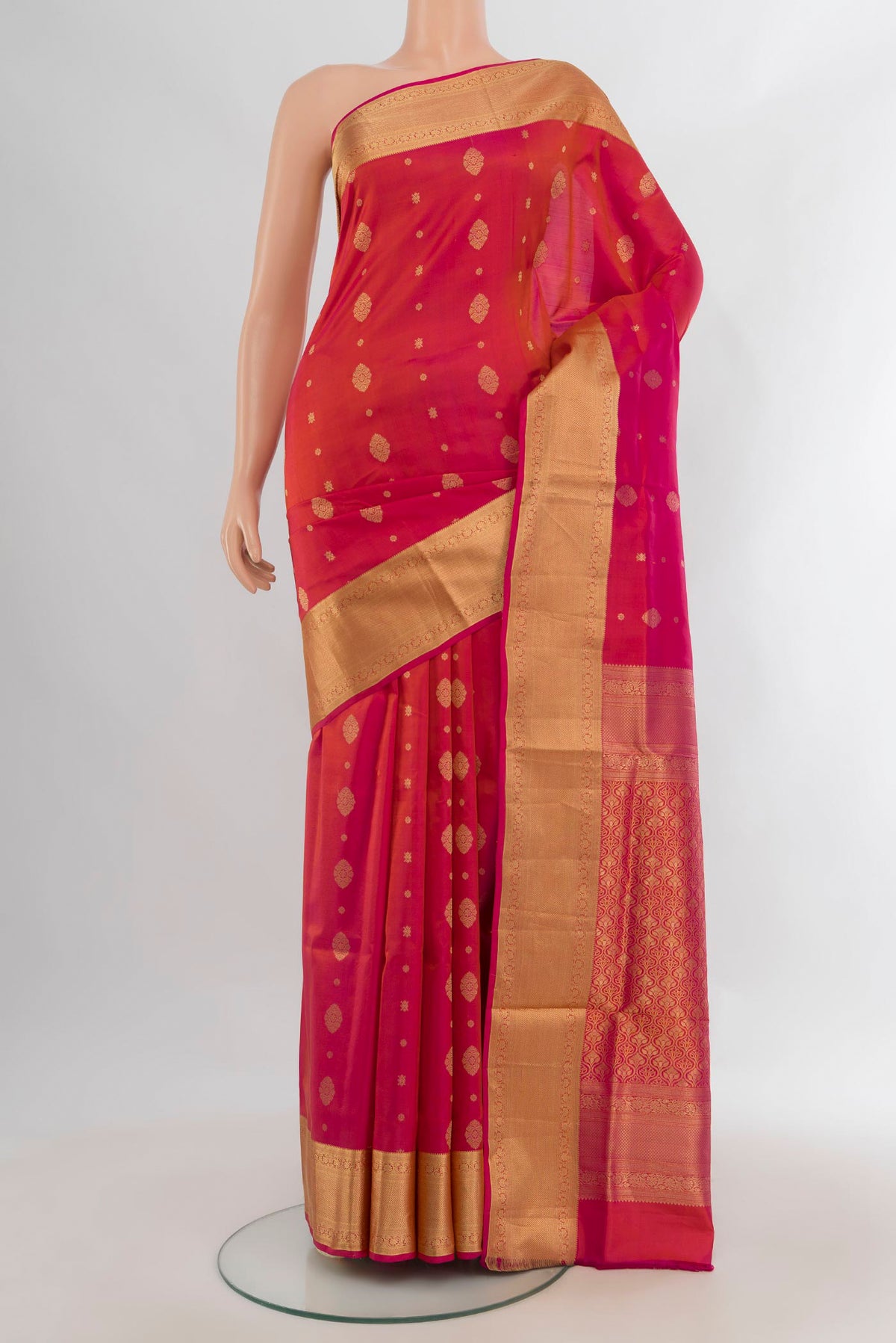 Pure Silk Orange Soft Saree with Zari Butta on the body and Zari Border.  displayed on a mannequin